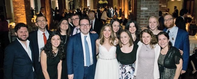 Many guests surround Michelle Barras and Alexander Rosenberg at their wedding